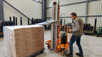 Operator walking the Ripack Turbopack V2 around a shrink-covered pallet