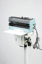AIE AC Series pneumatic constant heat foot sealer mesh-textured jaws and work table, three-quarter view