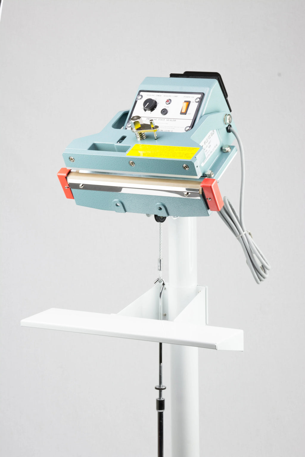 AIE FIT Series tilt angle impulse foot sealer sealing head and table, three-quarter view