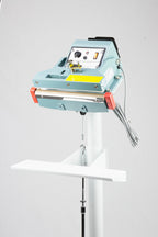 AIE FIT Series tilt angle impulse foot sealer sealing head and table, three-quarter view