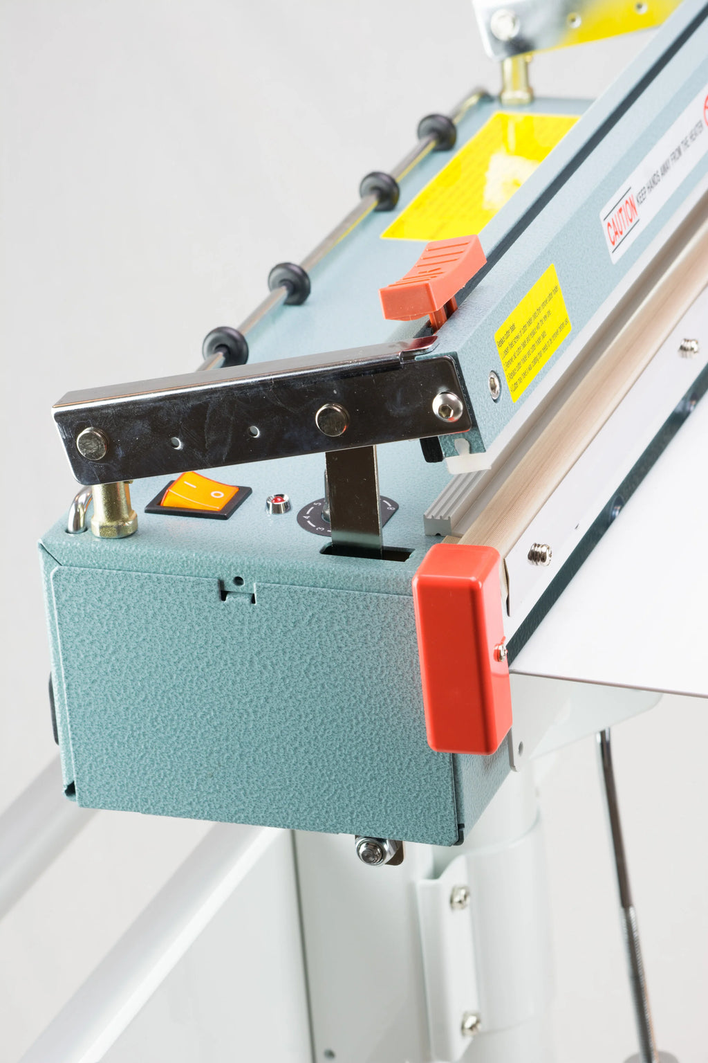 AIE FC Series impulse foot sealer with trimmer trimmer blade carriage, close-up
