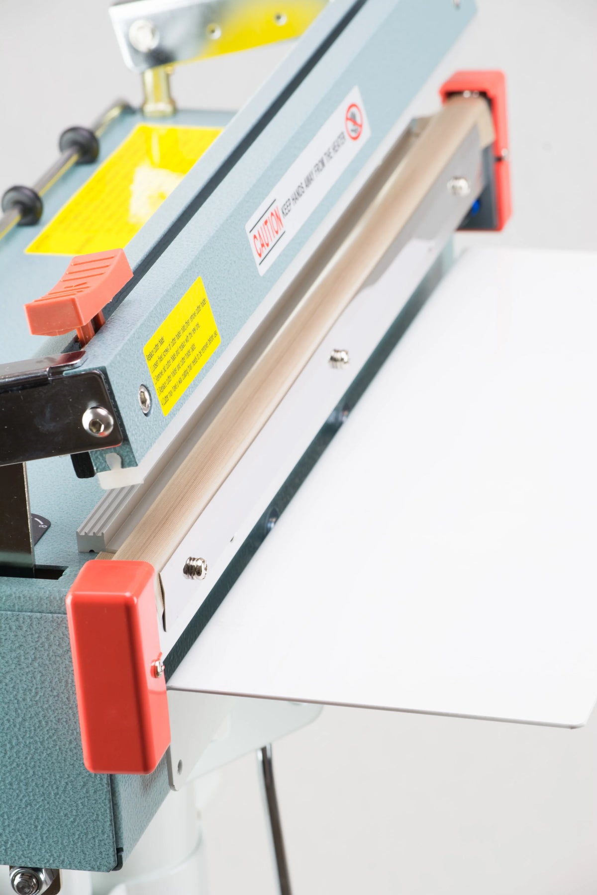 AIE FC Series impulse foot sealer with trimmer open throat and seal bar, close-up