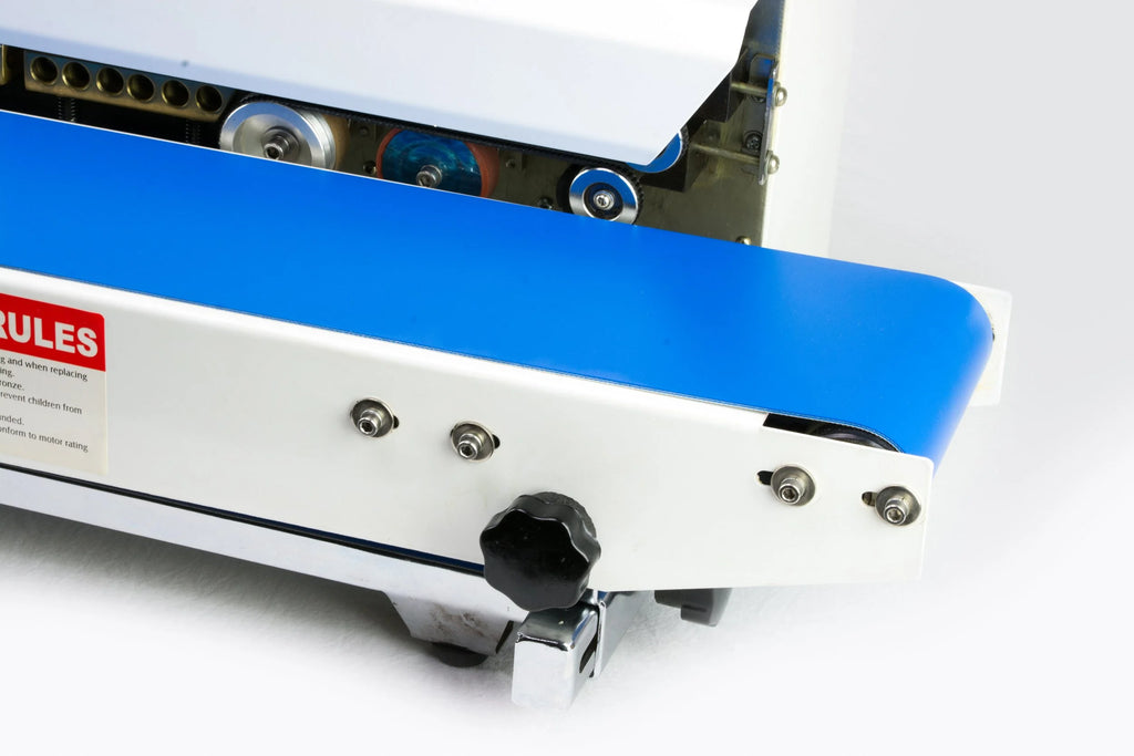 AIE B6 Series tabletop band sealer conveyor belt and adjustment knobs, close-up