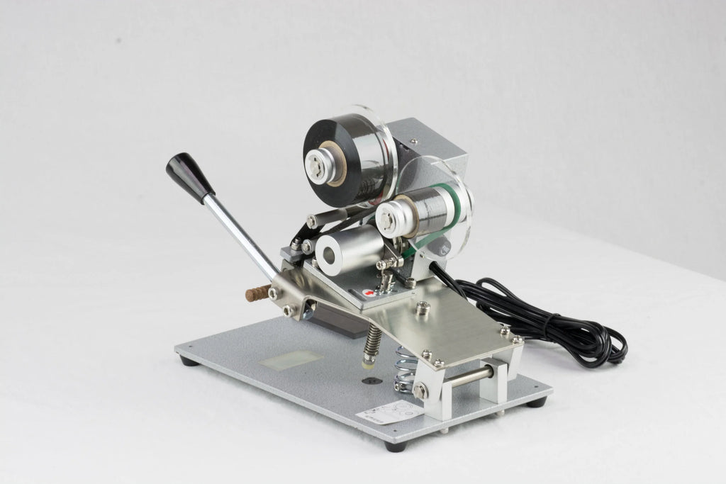 AIE DHH 3-line manual hot stamp imprinter print head and foil rolls, close-up