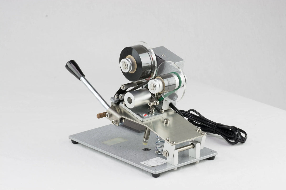 AIE DHH 3-line manual hot stamp imprinter print head and foil rolls, close-up