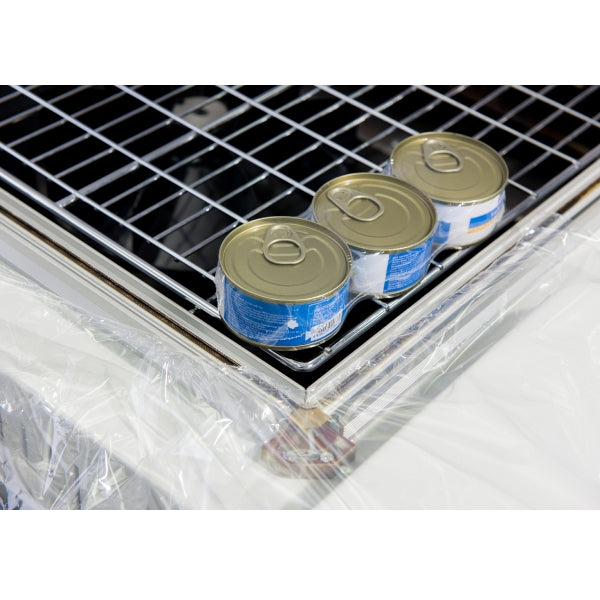 Shrink-wrapped cans on the mesh tray of the Maripak Compack 5800HC