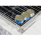 Shrink-wrapped cans on the mesh tray of the Maripak Compack 5800i